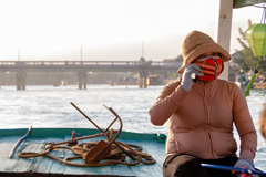 Woman driving a boat in Hoi An