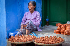 Old lady selling clay things in Hoi An