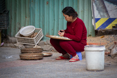 Woman cooking out by the street